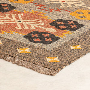 Close-up of a patterned rug with geometric design on a light background