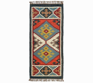Woven kilim rug with geometric pattern on a white background