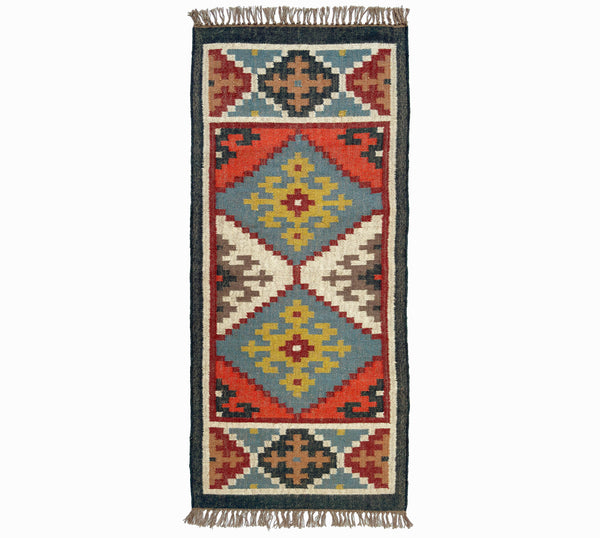 Woven kilim rug with geometric pattern on a white background