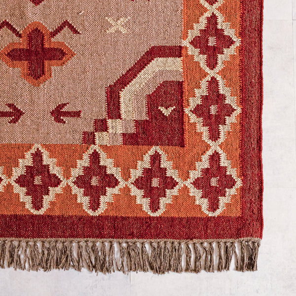 Close-up of a wool jute kilim  rug with geometric designs on a white background
