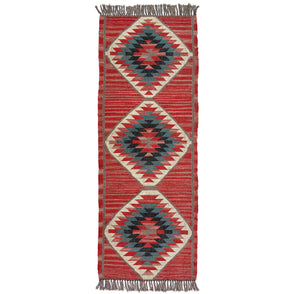 Woven kilim runner rug with geometric pattern on a white background